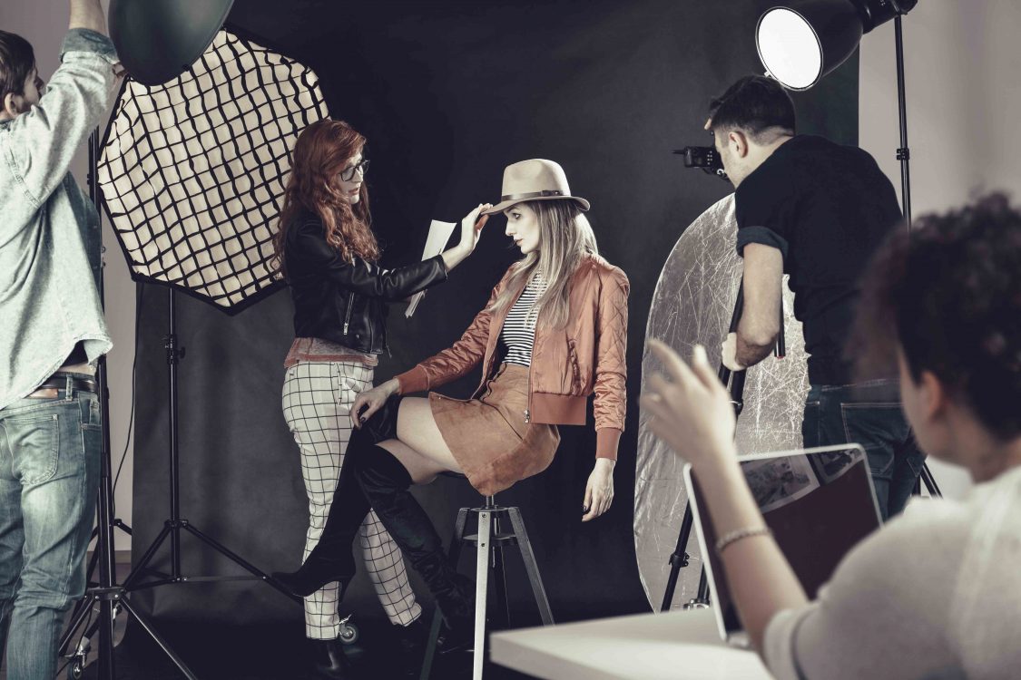 Fashion stylist with model at photoshoot