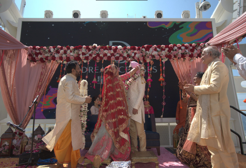 Wedding Phera in Zouk outdoor beach club; Mandap set on stage risers in water